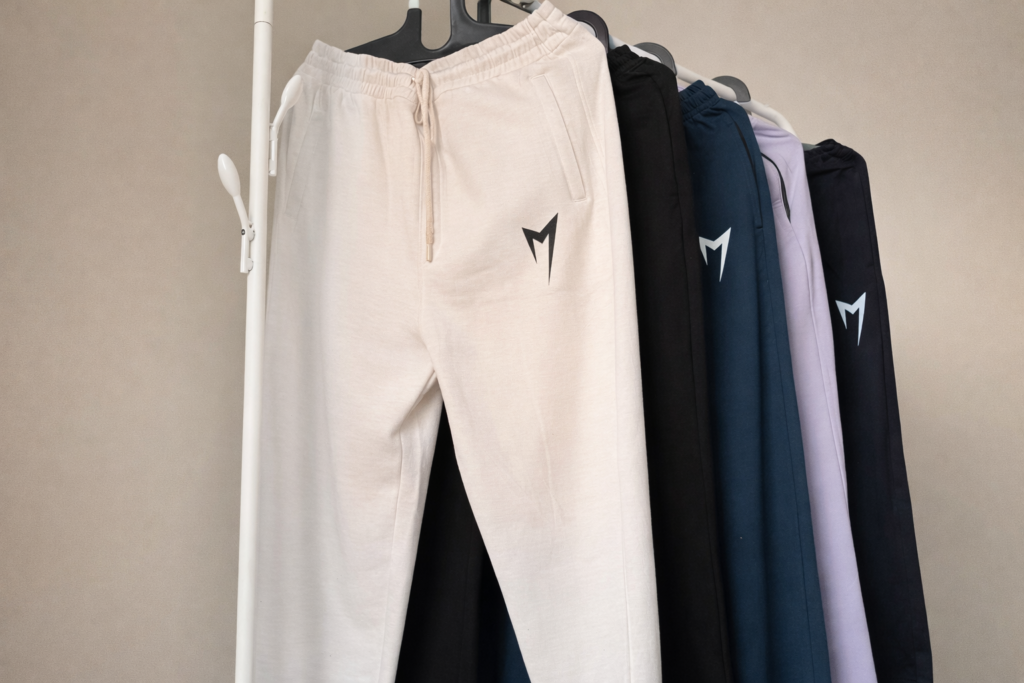 Partner-designed premium track pants in multiple colors with elastic waistband and modern logo design
